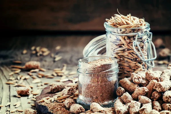 Oat bran, grain oats, oat flour, in glass jars — стоковое фото
