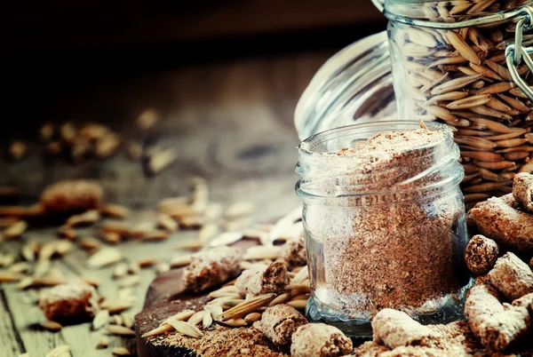 Oat bran, grain oats, oat flour, in glass jars — стоковое фото