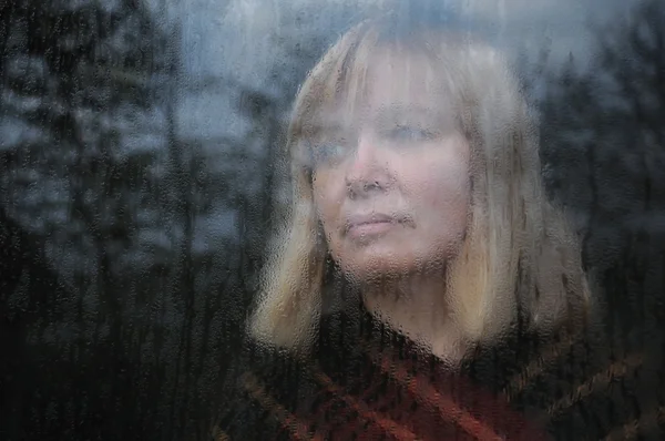 Портрет женщины через окно — стоковое фото